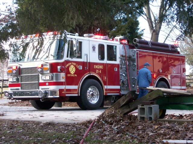 Firefighter Dave Vining operates Engine 21-4 at shed fire in Nottingham.